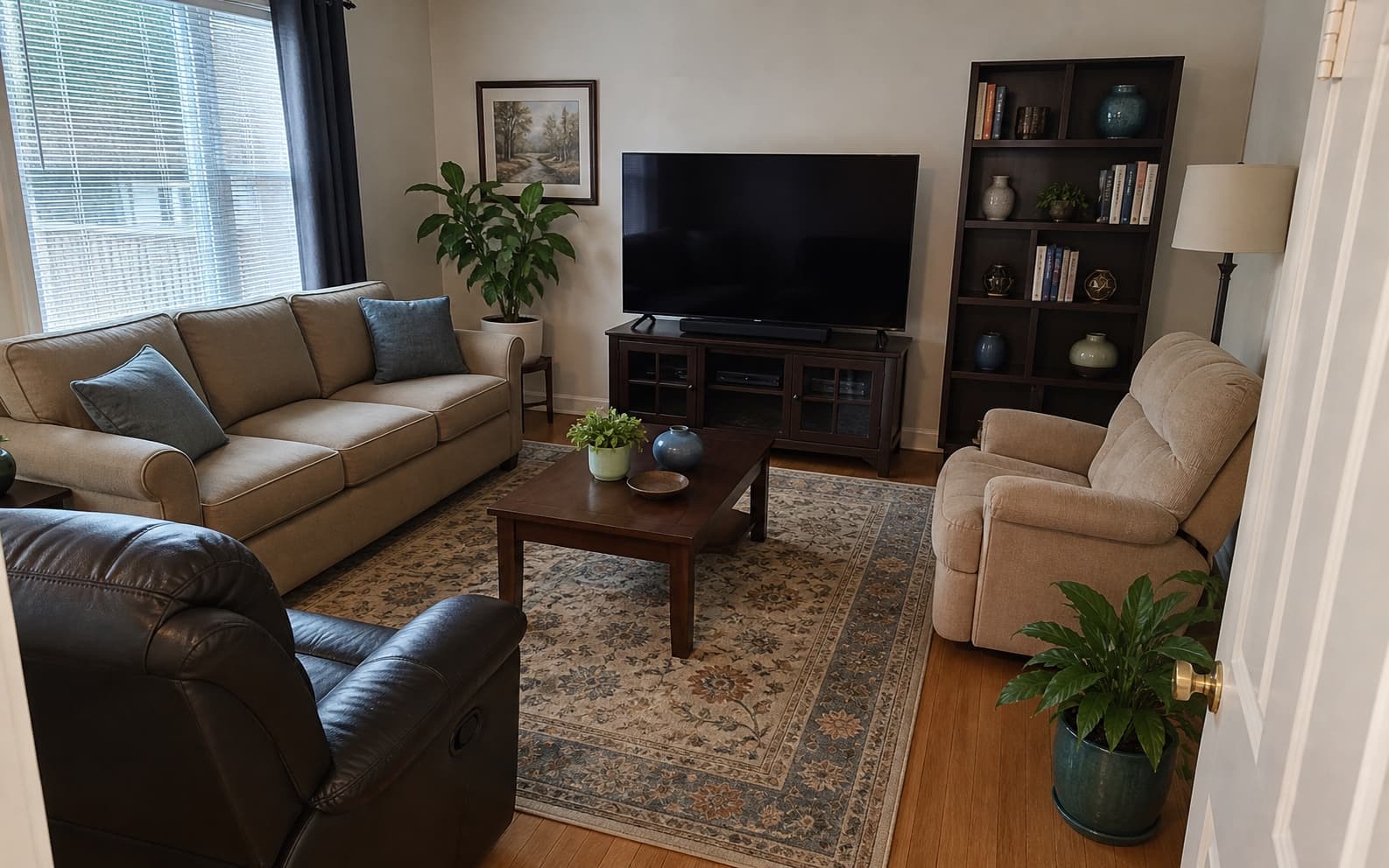 Example living room with a sofa, armchairs, coffee table, television, and shelving